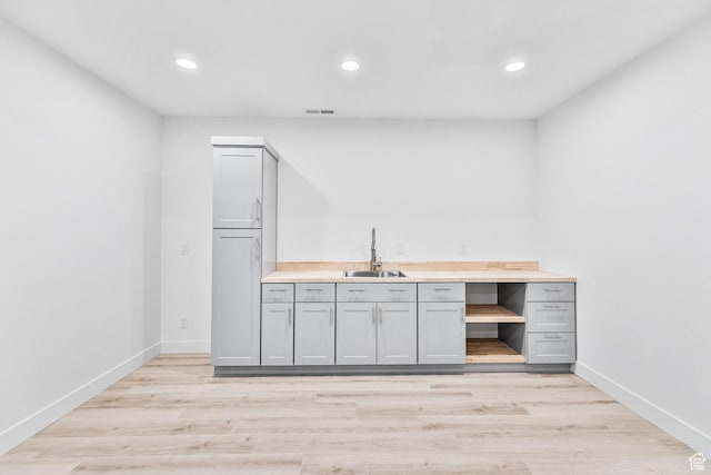 94 S 950 E, Hyde Park, UT 84318 - bar featuring a sink, light wood-type flooring, baseboards, and recessed lighting