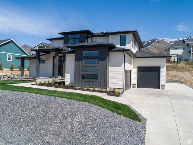 94 S 950 E, Hyde Park, UT 84318 - prairie-style house with board and batten siding, a mountain view, a garage, and concrete driveway