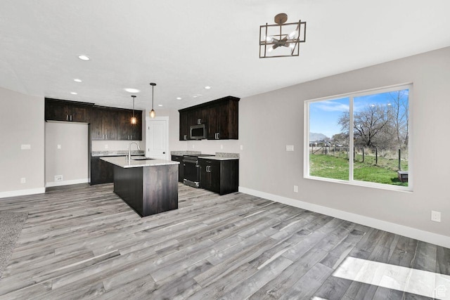 3005 W 3300 S, West Haven, UT 84401 - kitchen with a sink, light countertops, stainless steel microwave, and light wood-style flooring