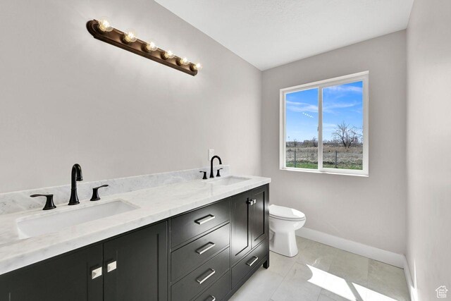 3005 W 3300 S, West Haven, UT 84401 - full bathroom featuring a sink, baseboards, double vanity, and toilet