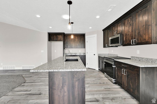 3005 W 3300 S, West Haven, UT 84401 - kitchen with a sink, visible vents, light wood-style flooring, and stainless steel appliances