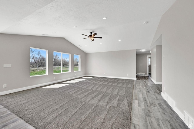 3005 W 3300 S, West Haven, UT 84401 - unfurnished living room featuring baseboards, vaulted ceiling, a ceiling fan, visible vents, and wood finished floors