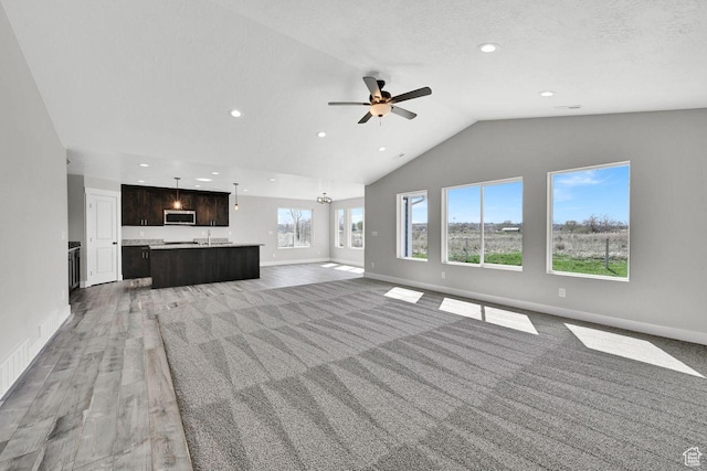 3005 W 3300 S, West Haven, UT 84401 - unfurnished living room featuring baseboards, ceiling fan, light wood-style floors, recessed lighting, and high vaulted ceiling