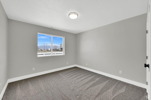 3005 W 3300 S, West Haven, UT 84401 - empty room with baseboards, visible vents, and dark colored carpet