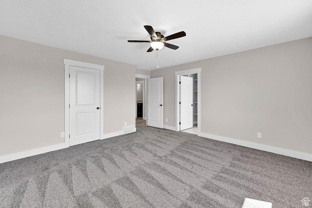 3005 W 3300 S, West Haven, UT 84401 - unfurnished bedroom featuring baseboards, a spacious closet, a ceiling fan, carpet floors, and visible vents