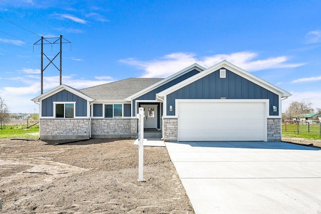 3005 W 3300 S, West Haven, UT 84401 - craftsman-style home featuring concrete driveway, stone siding, board and batten siding, a garage, and fence