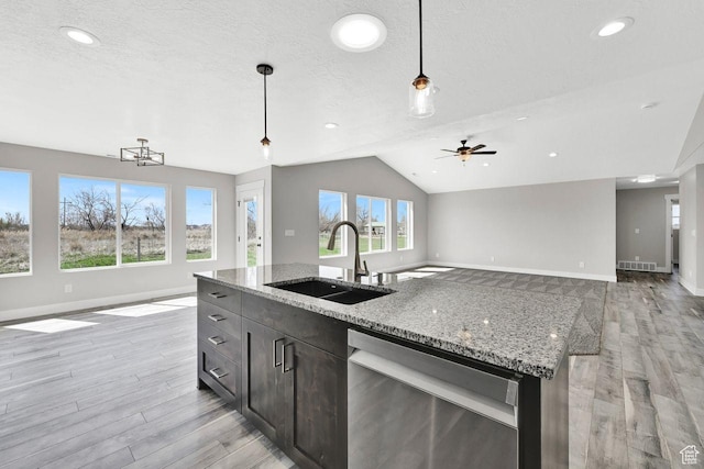 3005 W 3300 S, West Haven, UT 84401 - kitchen with baseboards, a sink, open floor plan, light wood finished floors, and stainless steel dishwasher
