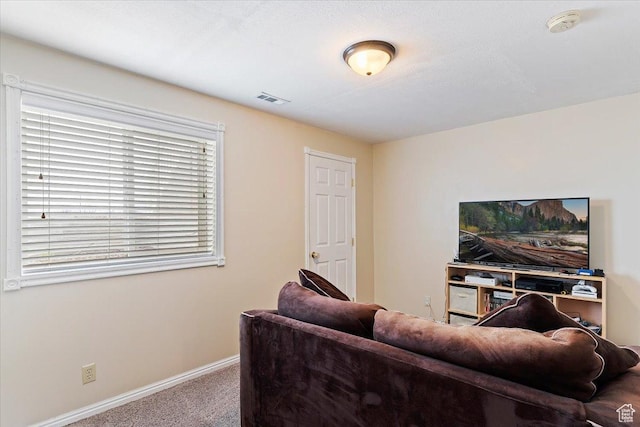 living area featuring carpet flooring, visible vents, and baseboards