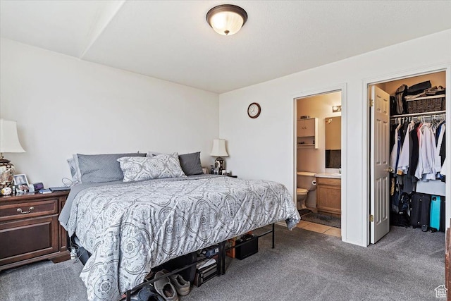 bedroom featuring a walk in closet, a closet, carpet, and connected bathroom