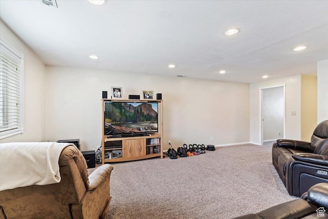 carpeted living room featuring baseboards and recessed lighting
