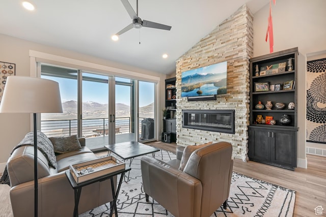 11285 N Shoreline Ct, Hideout, UT 84036 - living area featuring high vaulted ceiling, ceiling fan, a fireplace, light wood-style flooring, and visible vents
