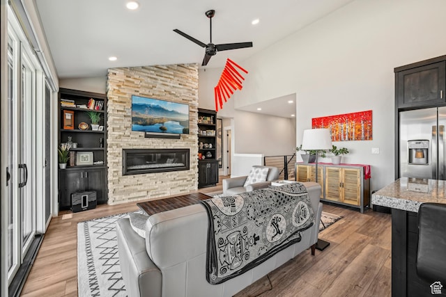 11285 N Shoreline Ct, Hideout, UT 84036 - living room featuring light wood-style flooring, a ceiling fan, high vaulted ceiling, and a fireplace