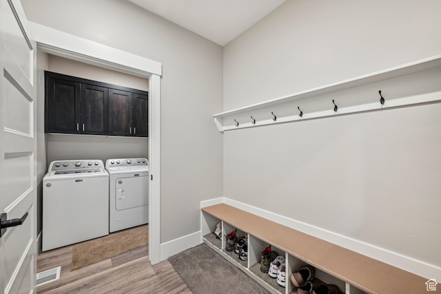 11285 N Shoreline Ct, Hideout, UT 84036 - laundry room featuring independent washer and dryer, light wood-type flooring, visible vents, and cabinet space