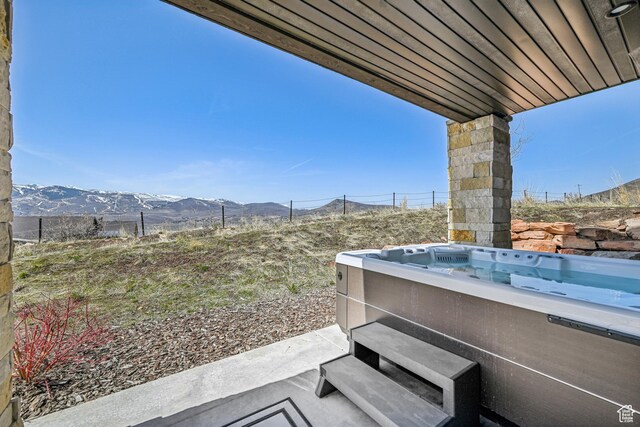 11285 N Shoreline Ct, Hideout, UT 84036 - view of patio with a mountain view, fence, and a hot tub