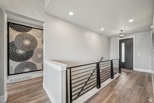 11285 N Shoreline Ct, Hideout, UT 84036 - corridor featuring wood finished floors, visible vents, an upstairs landing, and recessed lighting
