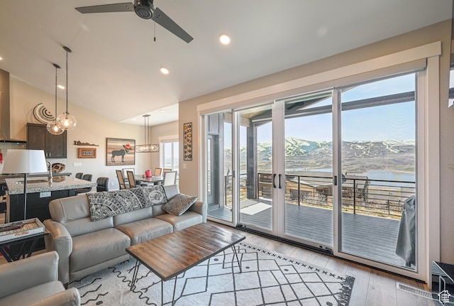 11285 N Shoreline Ct, Hideout, UT 84036 - living room featuring lofted ceiling, recessed lighting, visible vents, ceiling fan, and light wood finished floors