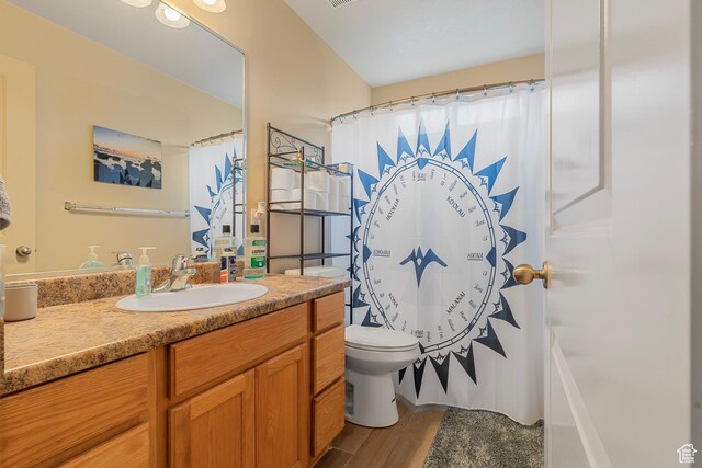 2930 E 450 N Unit F6, St George, UT 84790 - bathroom featuring curtained shower, wood finished floors, toilet, and vanity