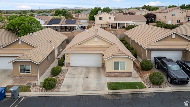 2930 E 450 N Unit F6, St George, UT 84790 - view of front of house with a residential view, a tiled roof, concrete driveway, a garage, and stucco siding