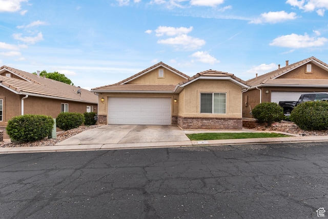 2930 E 450 N Unit F6, St George, UT 84790 - ranch-style home featuring concrete driveway, an attached garage, a tile roof, and stucco siding