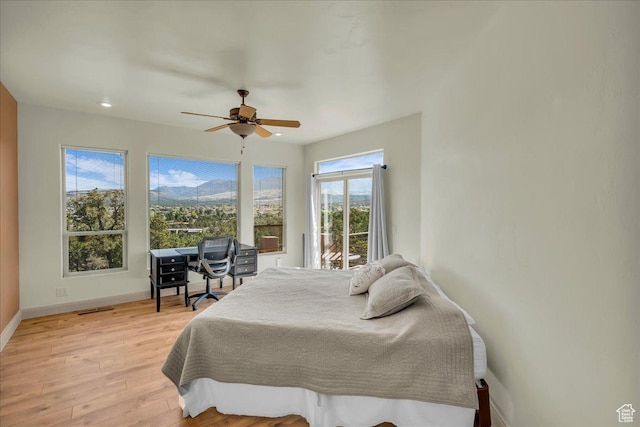 bedroom featuring light wood-type flooring, a ceiling fan, visible vents, access to exterior, and baseboards