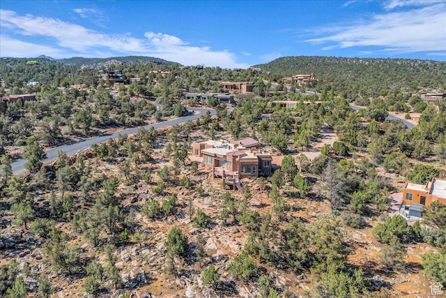 aerial view with a wooded view and a mountain view