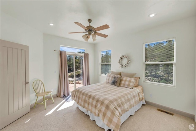 bedroom featuring visible vents, baseboards, a ceiling fan, access to exterior, and light colored carpet