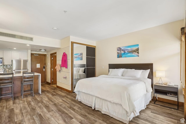 3720 N Sundial Ct Unit Cg02, Park City, UT 84098 - bedroom featuring visible vents, freestanding refrigerator, a closet, and wood finished floors