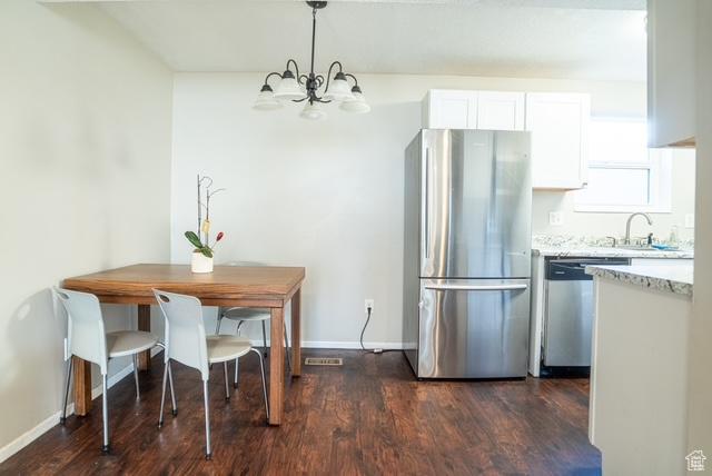 3198 S 300 E Unit 10, South Salt Lake, UT 84115 - dining space with an inviting chandelier, baseboards, dark wood finished floors, and visible vents
