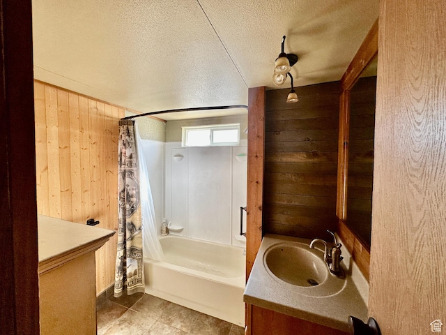 967 E Rudder St Unit 53, Garden City, UT 84028 - bathroom with shower / bath combo, a textured ceiling, wooden walls, vanity, and tile patterned floors