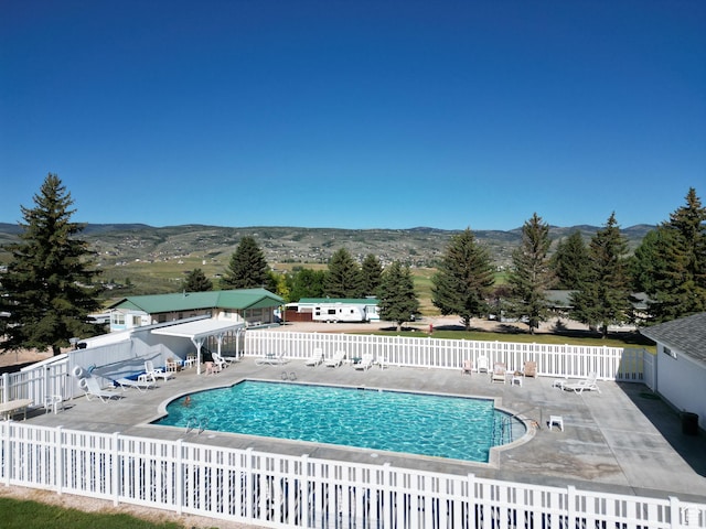 967 E Rudder St Unit 53, Garden City, UT 84028 - community pool with a mountain view, fence, and a patio
