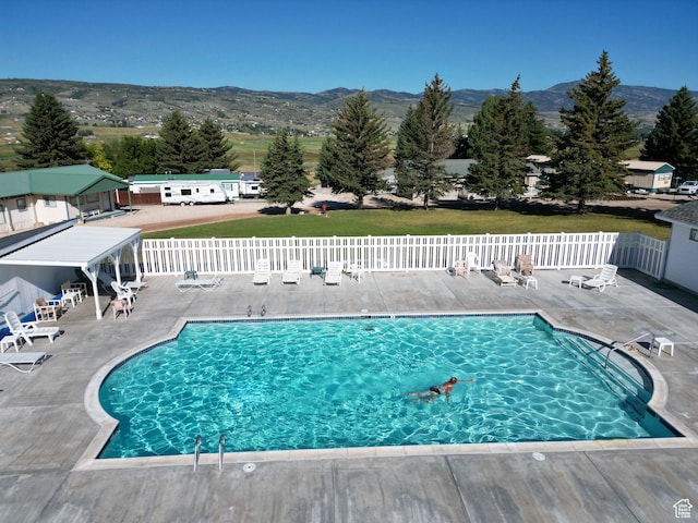 967 E Rudder St Unit 53, Garden City, UT 84028 - pool featuring a patio area, fence, and a mountain view