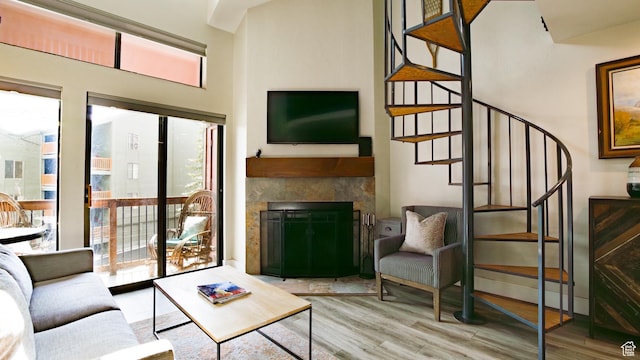 1530 Empire Ave Unit 302, Park City, UT 84060 - living area with wood finished floors, a glass covered fireplace, and stairway