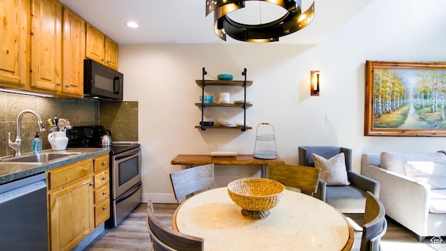 1530 Empire Ave Unit 302, Park City, UT 84060 - kitchen with dishwashing machine, black microwave, dark countertops, a sink, and electric stove