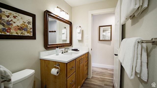 1530 Empire Ave Unit 302, Park City, UT 84060 - bathroom featuring toilet, vanity, wood finished floors, and baseboards