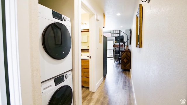 1530 Empire Ave Unit 302, Park City, UT 84060 - clothes washing area featuring baseboards, stacked washing maching and dryer, laundry area, recessed lighting, and light wood finished floors