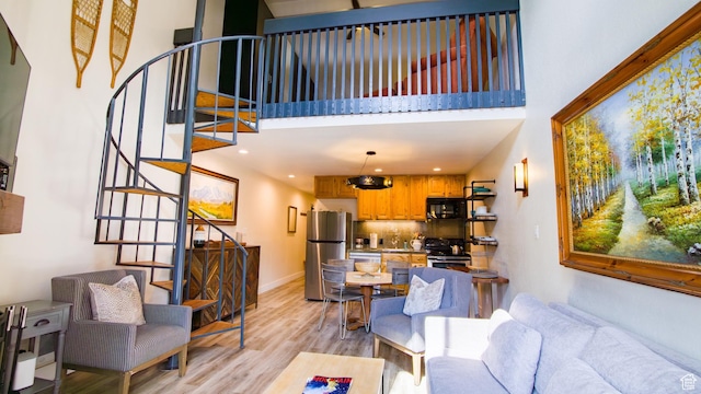 1530 Empire Ave Unit 302, Park City, UT 84060 - living room with light wood finished floors, a towering ceiling, and stairs