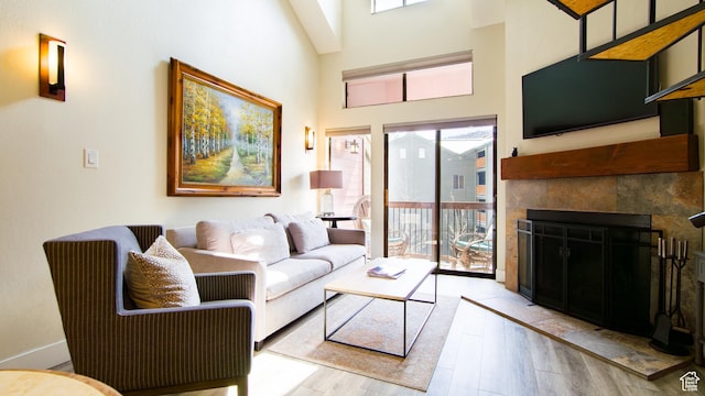 1530 Empire Ave Unit 302, Park City, UT 84060 - living area with a tile fireplace, light wood finished floors, and a towering ceiling