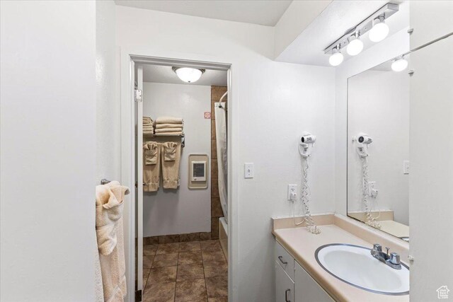 2176 S Bear Blvd, Garden City, UT 84028 - bathroom with vanity, shower / bath combo with shower curtain, stone finish flooring, and heating unit