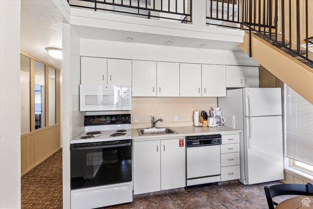 2176 S Bear Blvd, Garden City, UT 84028 - kitchen featuring white appliances, light countertops, a sink, and white cabinetry
