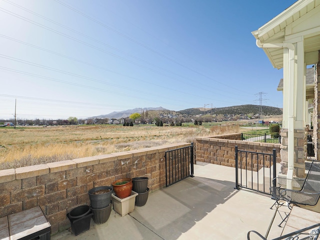 8092 W Rock Creek Cove Ln, Eagle Mountain, UT 84005 - view of patio featuring fence and a mountain view