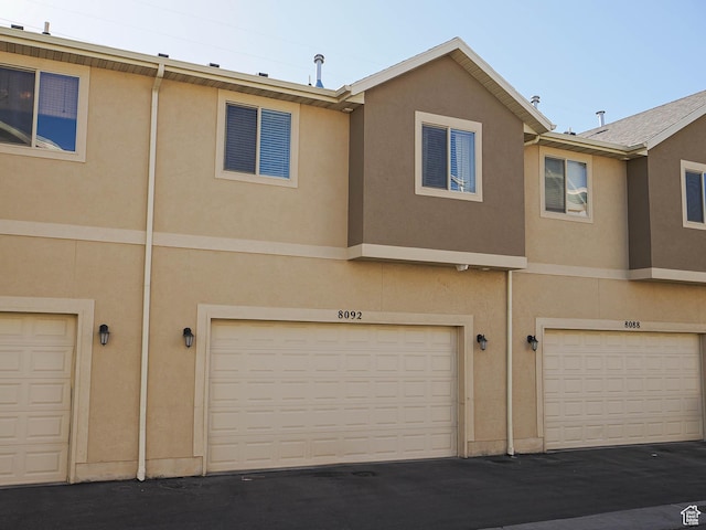 8092 W Rock Creek Cove Ln, Eagle Mountain, UT 84005 - back of property with a garage and stucco siding