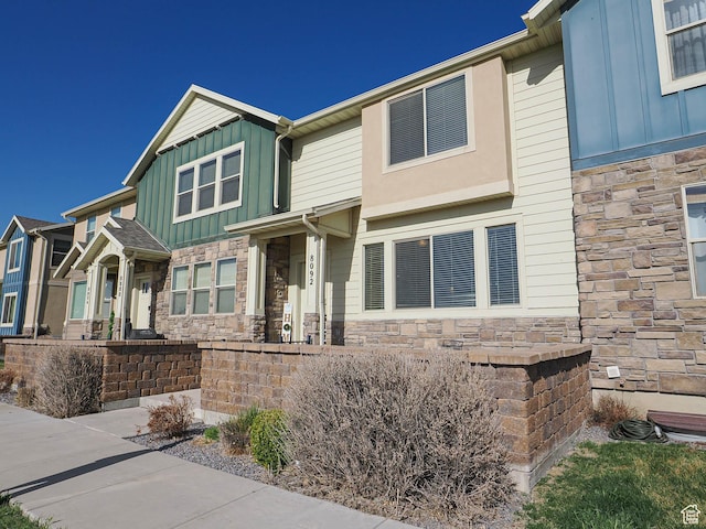 view of front of home featuring stone siding and board and batten siding