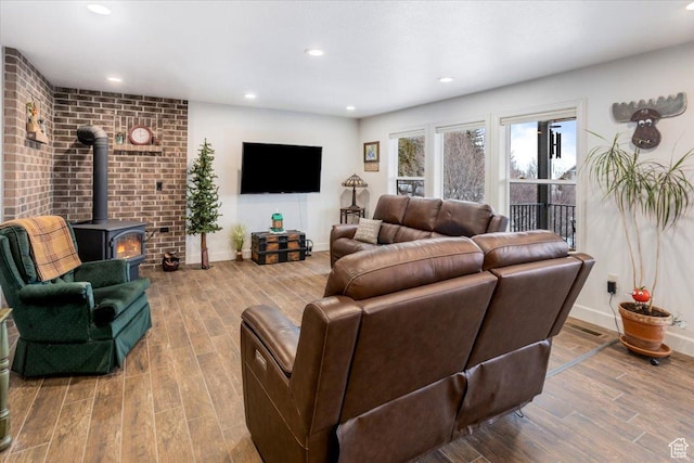 1510 S Mahogany Dr, Garden City, UT 84028 - living area featuring wood finished floors, a wood stove, baseboards, and recessed lighting