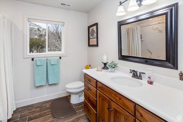 1510 S Mahogany Dr, Garden City, UT 84028 - full bath with visible vents, baseboards, toilet, vanity, and wood finished floors