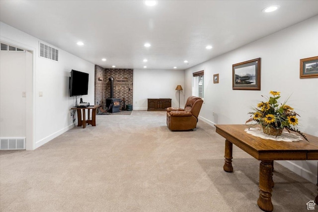 1510 S Mahogany Dr, Garden City, UT 84028 - sitting room featuring visible vents, a wood stove, and light colored carpet