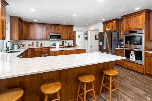 1510 S Mahogany Dr, Garden City, UT 84028 - kitchen featuring tasteful backsplash, a sink, appliances with stainless steel finishes, recessed lighting, and dark wood-type flooring