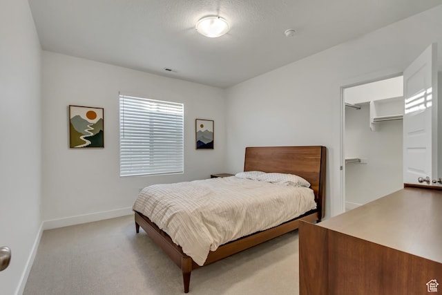 1919 S Sawmill Blvd E, Heber City, UT 84032 - carpeted bedroom with a spacious closet, an AC wall unit, and baseboards