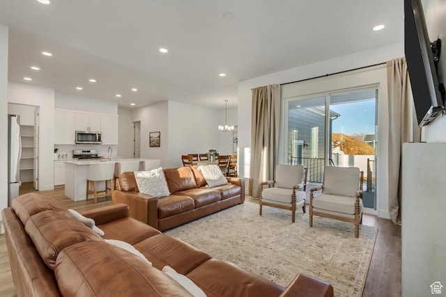 1919 S Sawmill Blvd E, Heber City, UT 84032 - living area with light wood finished floors, an inviting chandelier, and recessed lighting