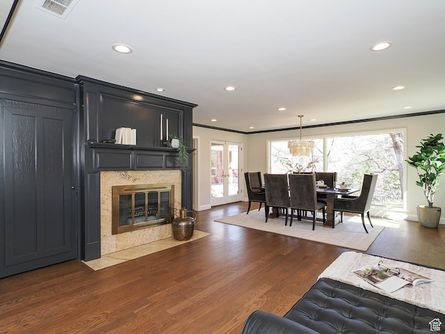 2463 E Michigan Ave S, Salt Lake City, UT 84108 - living area featuring crown molding, plenty of natural light, dark wood-style flooring, recessed lighting, and a premium fireplace