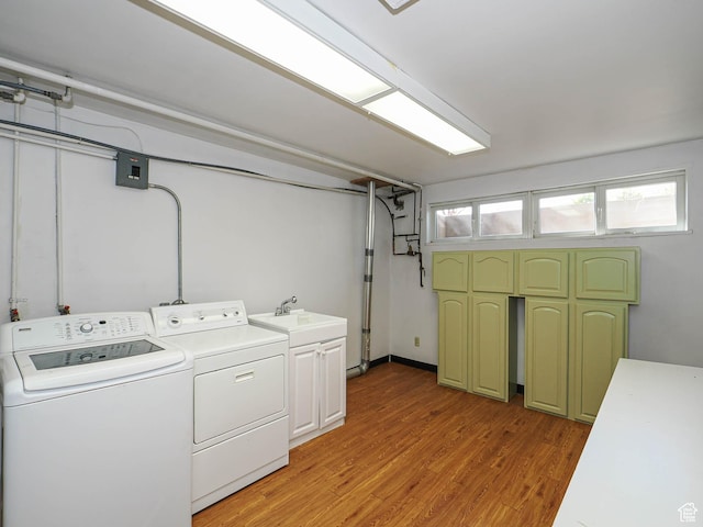 2463 E Michigan Ave S, Salt Lake City, UT 84108 - laundry room with washer and clothes dryer, cabinet space, and light wood-type flooring